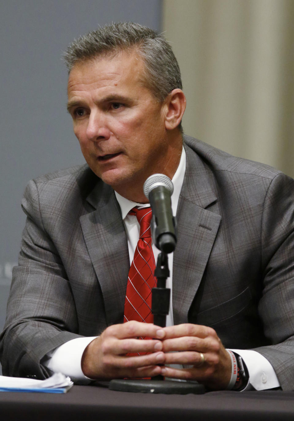 Ohio State football coach Urban Meyer answers questions during a news conference in Columbus, Ohio, Wednesday, Aug. 22, 2018. Ohio State suspended Meyer on Wednesday for three games for mishandling domestic violence accusations, punishing one of the sport's most prominent leaders for keeping an assistant on staff for several years after the coach's wife accused him of abuse. Athletic director Gene Smith was suspended from Aug. 31 through Sept. 16. (AP Photo/Paul Vernon)