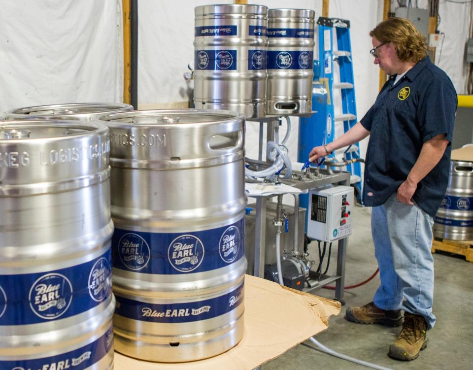 Steve Morris cleans kegs in preparation for the opening of Smyrna's Blue Earl Brewing Co. in May 2015.