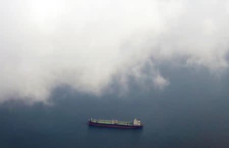 A tanker travels through the Singapore Strait July 7, 2014. REUTERS/Tim Wimborne/File Photo