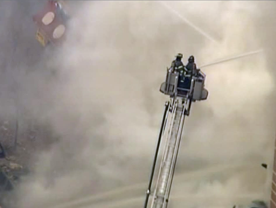 In this image taken from video from WABC, firefighters battle a blaze at the site of a possible explosion and building collapse in the East Harlem neighborhood of New York, Wednesday, March 12, 2014. (AP Photo/WABC-TV)