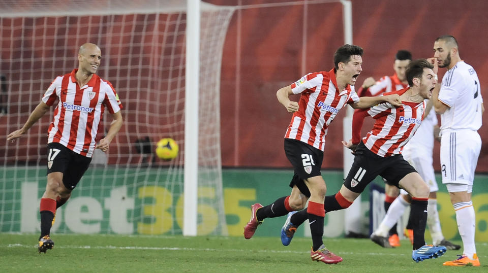 Athletic Bilbao's Ibai Gomez, second right, celebrates between his teammates Mikel Rico, left, and Ander Herrera, center, after scoring his goal resulting in a tie, during the Spanish League soccer match between Athletic Bilbao and Real Madrid, at San Mames stadium in Bilbao, Spain, Sunday, Feb. 2, 2014. (AP Photo/Alvaro Barrientos)