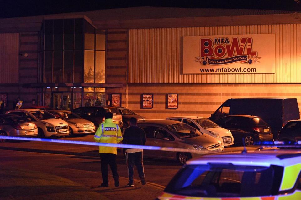 Police stand guard inside a cordon near the MFA Bowl at The Bermuda leisure park in Nuneaton (AFP/Getty Images)