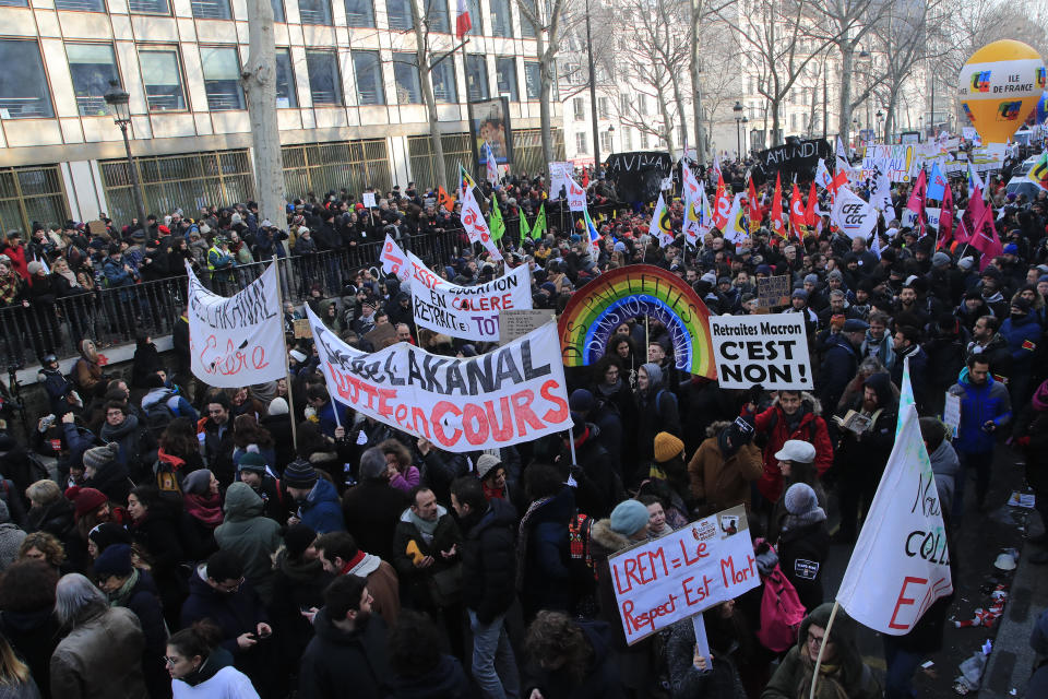 Protesters march during a demonstration, Friday, Jan. 24, 2020 in Paris. French unions are holding last-ditch strikes and protests around the country Friday as the government unveils a divisive bill redesigning the national retirement system. (AP Photo/Michel Euler)