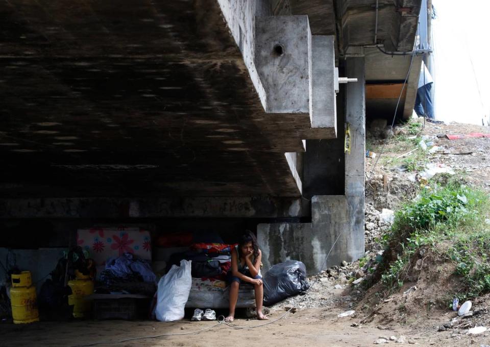 Mileydi Duarte, who was evacuated by her family, rests under a highway bridge as she waits for space at a shelter before Hurricane Iota makes landfall in El Progreso Yoro, Honduras, Monday, November 16, 2020.