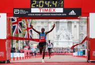 Athletics - Virgin Money London Marathon - London - 26/4/15 Kenya's Eliud Kipchoge celebrates after winning the Men's Elite race Reuters / Suzanne Plunkett Livepic