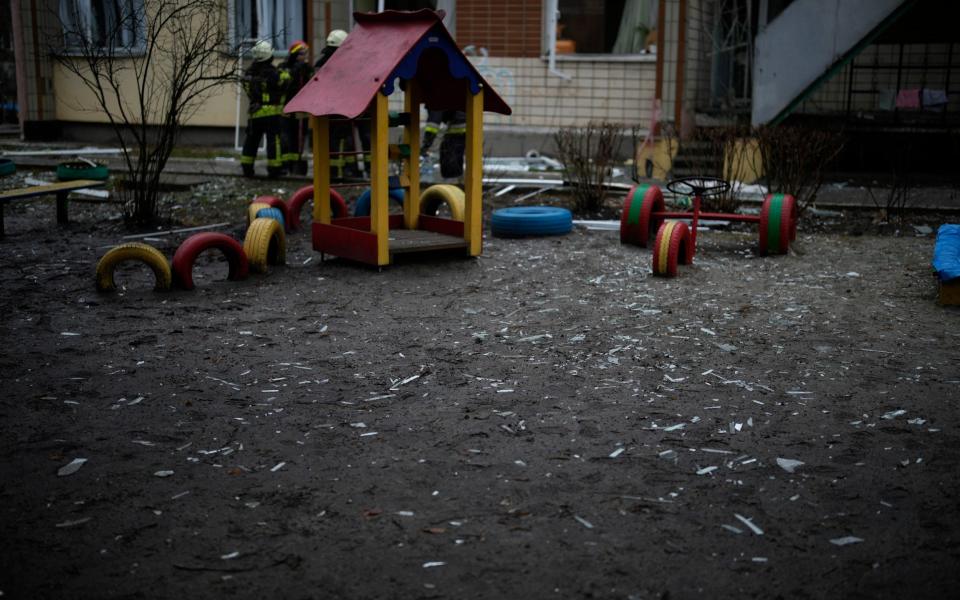 Shards of window glass are seen in the kindergarten at the scene where a helicopter crashed on civil infrastructure in Brovary - Daniel Cole/AP