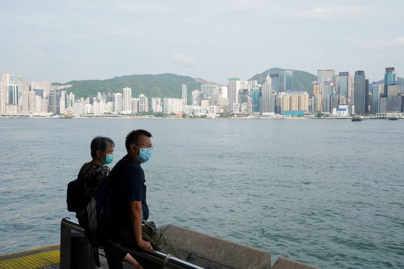 FILE PHOTO: People look on at the Tsim Sha Tsui ferry pier in Hong Kong