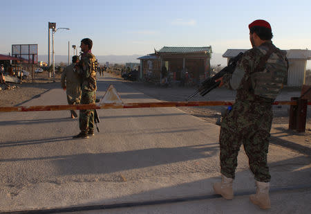 Afghan National Army (ANA) soldiers stand guard at the gate of an army base after a suicide blast in Khost province, Afghanistan November 23, 2018. REUTERS/Stringer