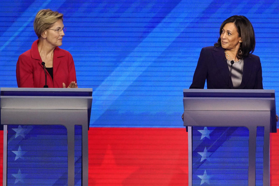 FILE - Democratic presidential candidate Sen. Elizabeth Warren, D-Mass., left and Sen. Kamala Harris, D-Calif., react, Sept. 12, 2019, during a Democratic presidential primary debate in Houston. (AP Photo/David J. Phillip, File)