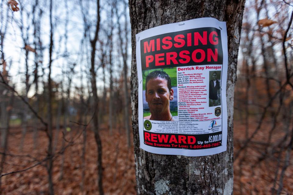 A missing person poster for Derrick Henagan hangs on a tree along M-135 in McMillan, Mich. On Aug. 4, 2008, 35-year-old Derrick Henagan was reportedly last seen in these woods.