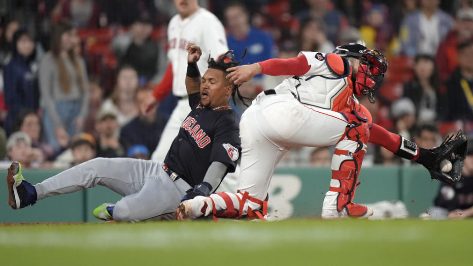 Cleveland Guardians’ José Ramírez, left, scores on a single by Estevan Florial, next to Boston Red Sox’s Connor Wong during the 11th inning of a baseball game Tuesday, April 16, 2024, in Boston. (AP Photo/Steven Senne)