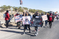 In this image provided by the Navajo Nation Office of the Speaker, family members and advocates participating in a walk on the Navajo Nation, Wednesday, May 5, 2021, near Window Rock, Ariz., to commemorate a day of awareness for the crisis of violence against Indigenous women and children. (Byron C. Shorty, Navajo Nation Office of the Speaker via AP)