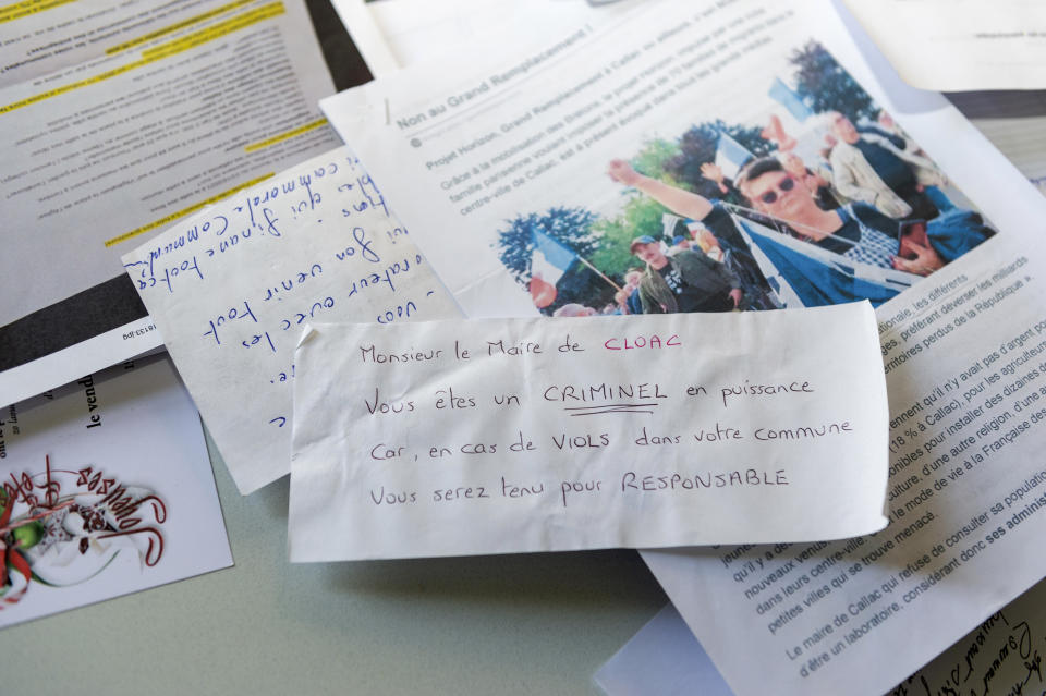 Some of the threatening letters to Jean-Yves Rolland, mayor of Callac, are pictured Dec.15, 2023. The far right cried victory in January 2023, when Rolland gave up his plan to house seven to 10 refugee families. (AP Photo/Mathieu Pattier)