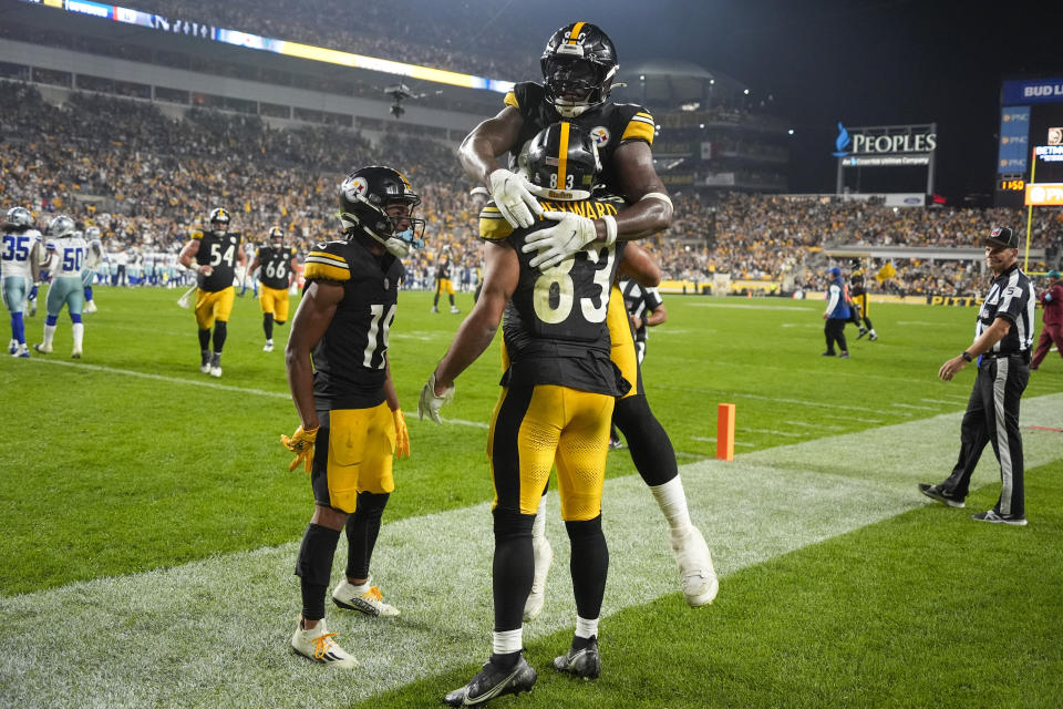 Pittsburgh Steelers tight end Connor Heyward (83) celebrates his touchdown catch with wide receiver Calvin Austin III (19) and tight end Darnell Washington, top, during the second half of an NFL football game against the Dallas Cowboys, Sunday, Oct. 6, 2024, in Pittsburgh. (AP Photo/Gene J. Puskar)