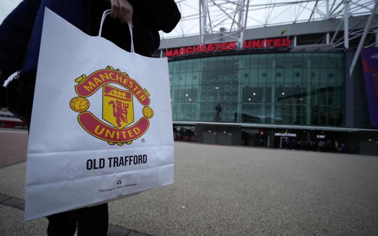 Manchester United fan walks away from Old Trafford with a branded paper bag - Manchester United fans fear ‘another Glazer’ after club is put up for sale - Christopher Furlong/Getty Images