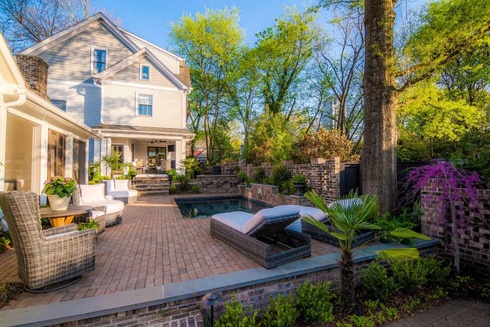 This Charleston-inspired oasis garden on 9th Street in Charlotte spans across two homes.