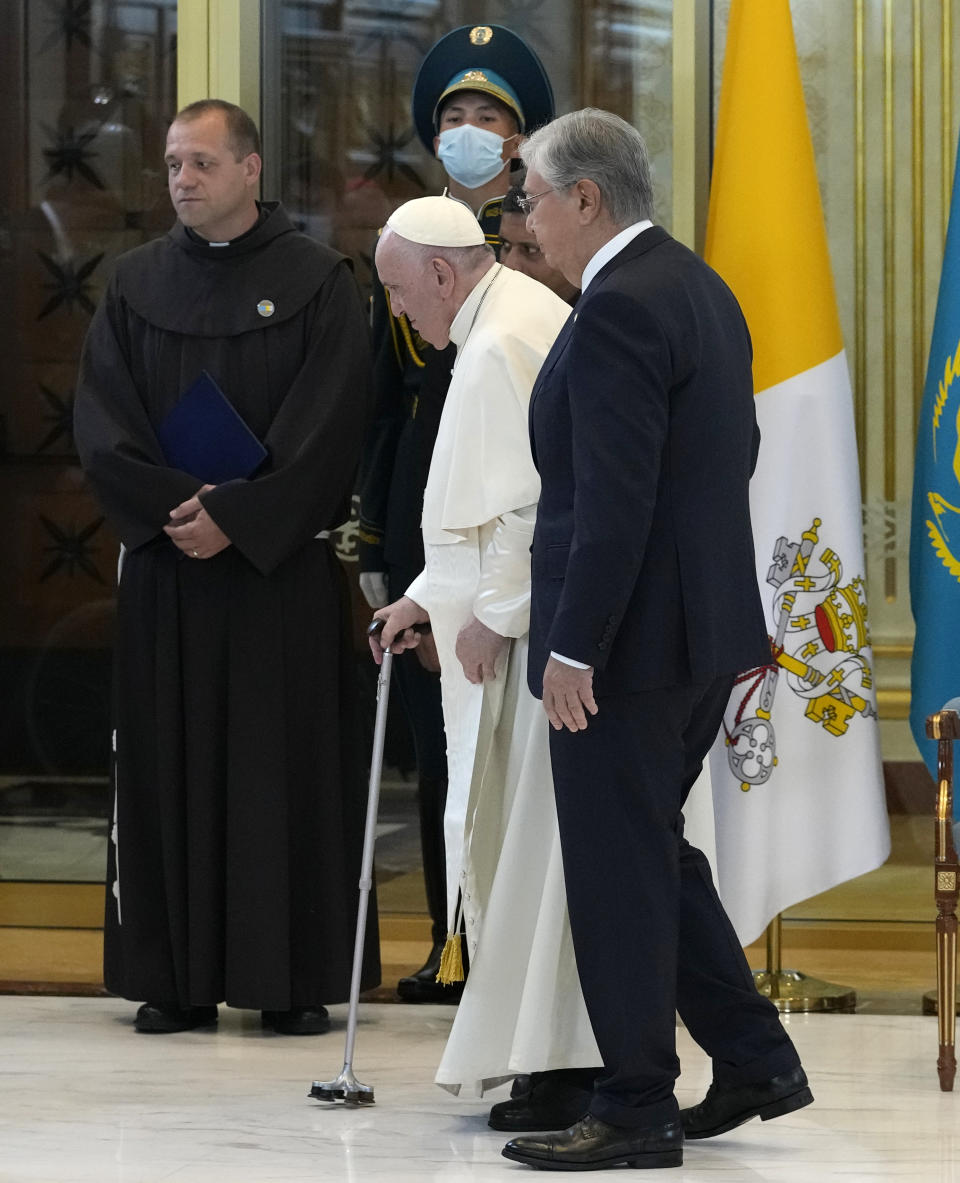 Pope Francis, left, meets the Kazakhstan's President Kassym-Jomart Tokayev as he arrives at Our-Sultan's International airport in Nur-Sultan, Kazakhstan, Tuesday, Sept. 13, 2022. Pope Francis begins a 3-days visit to the majority-Muslim former Soviet republic to minister to its tiny Catholic community and participate in a Kazakh-sponsored conference of world religious leaders. (AP Photo/Andrew Medichini)