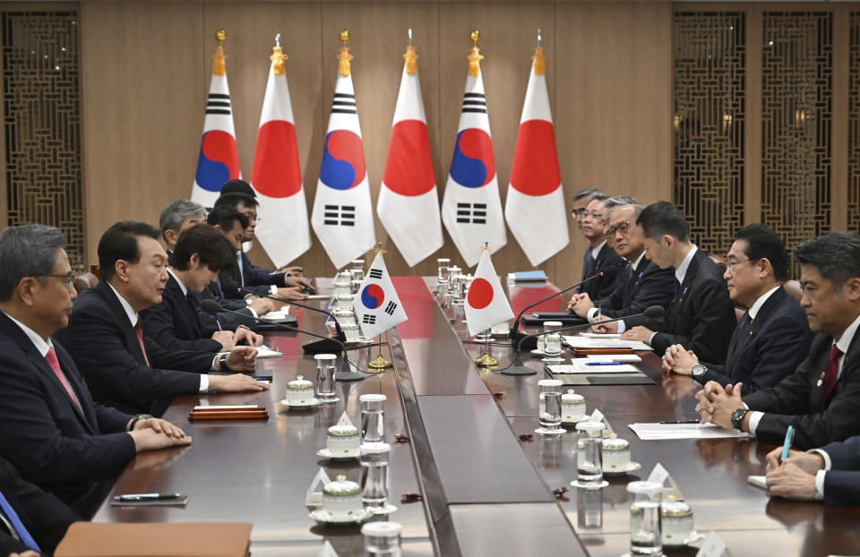 South Korean President Yoon Suk Yeol, second left, talks with Japanese Prime Minister Fumio Kishida, second right, during their meeting at the presidential office in Seoul Sunday, May 7, 2023. The leaders of South Korea and Japan met Sunday for their second summit in less than two months, as they push to mend long-running historical grievances and boost ties in the face of North Korea’s nuclear program and other regional challenges. (Jung Yeon-je/Pool Photo via AP)