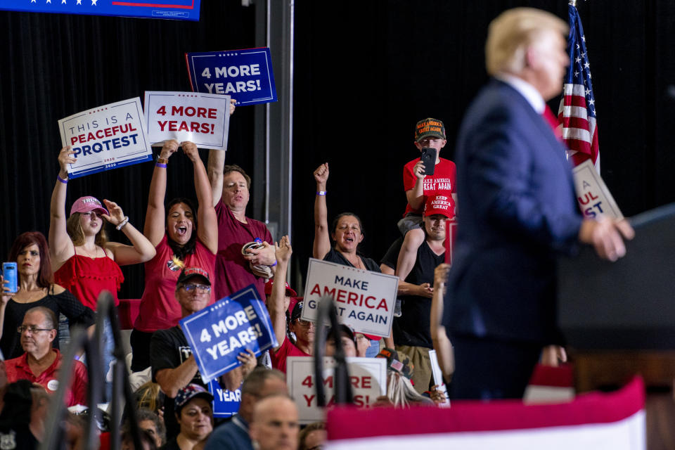 Supporters cheer as President Donald Trump speaks at a rally at Xtreme Manufacturing, Sunday, Sept. 13, 2020, in Henderson, Nev. (AP Photo/Andrew Harnik)