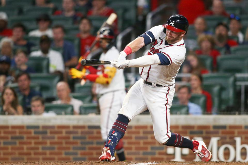 Atlanta Braves left fielder Robbie Grossman (15) hits a RBI single against the Houston Astros in the 10th inning Saturday, Aug. 20, 2022, at Truist Park in Atlanta.