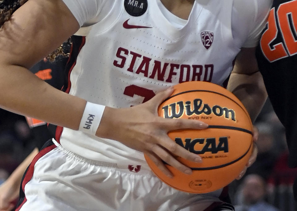 FILE - Stanford guard Haley Jones wears tape on her wrist with "KM19," honoring the school's soccer team goalkeeper Katie Meyer, while driving the ball against Oregon State during an NCAA college basketball game in the quarterfinals of the Pac-12 women's tournament March 3, 2022, in Las Vegas. There has been a lot of talk about the mental health struggles that many young athletes face, the pressures and vulnerabilities that can seem overwhelming — especially to those who feel compelled to shield their pain from the outside world. (AP Photo/David Becker, File)