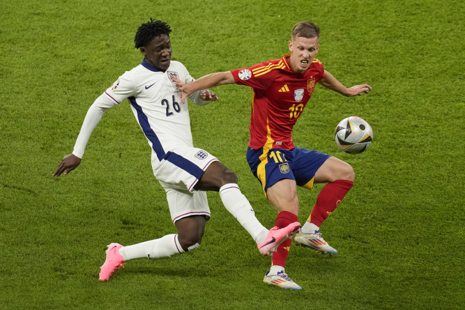 England's Kobbie Mainoo challenges for the ball with Spain's Dani Olmo during the final match between Spain and England at the Euro 2024 soccer tournament in Berlin, Germany, Sunday, July 14, 2024. (AP Photo/Andreea Alexandru)