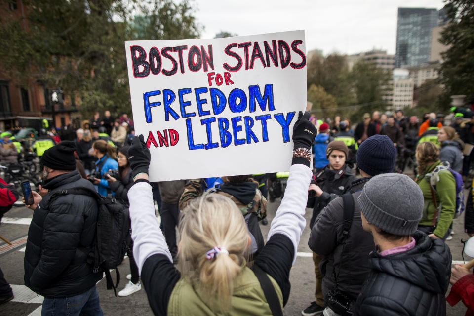 <p>A participant of an Alt-Right organized free speech event holds a sign that says “Boston Stands For Freedom And Liberty” across from the Massachusetts State House on Nov. 18, 2017, in Boston, Mass. (Photo: Scott Eisen/Getty Images) </p>