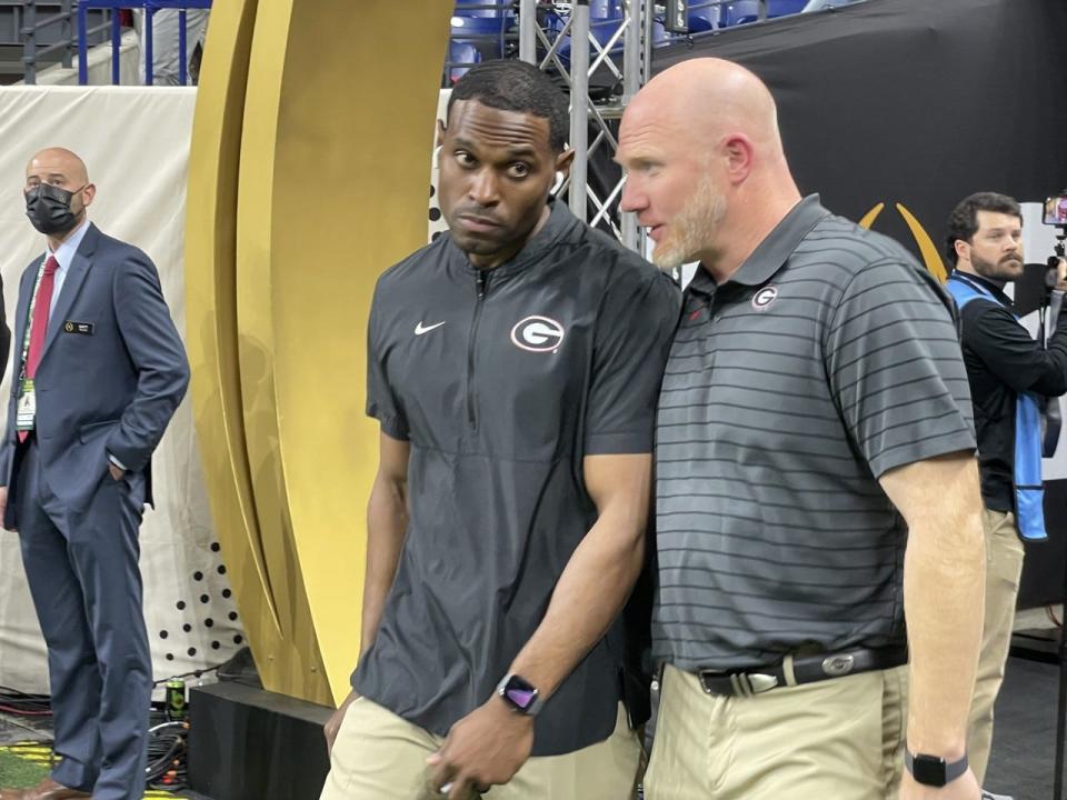 Former Georgia wide receivers coach Cortez Hankton, left, shown with special teams support staffer Scott Cochran at the Jan. 10 CFB national championship game, has been hired by LSU to coach Tigers receivers.