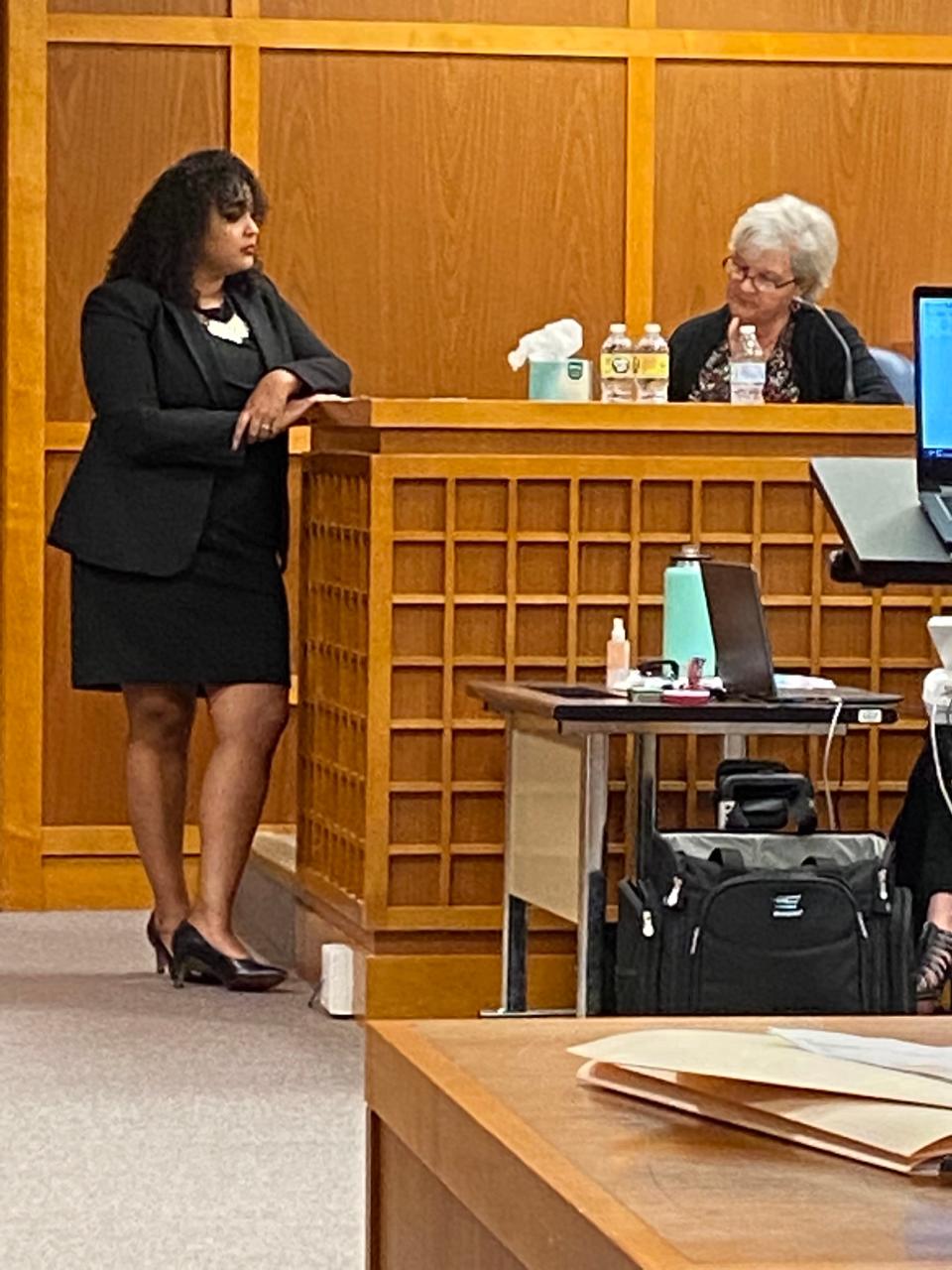 Janice Wheeler, right, identifies family photos for defense attorney Wilma Ramos.