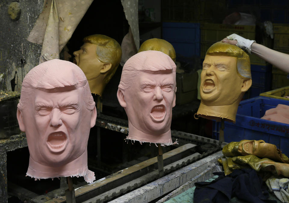 Workers add final touches on Donald Trump rubber masks