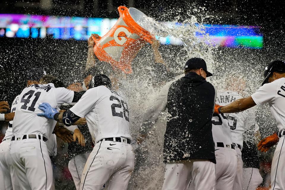 Detroit Tigers designated hitter Miguel Cabrera, behind Javier Baez, is doused after driving in the winning run in the ninth inning of a 4-3 victory over the Guardians on Thursday night. [Carlos Osorio/Associated Press]