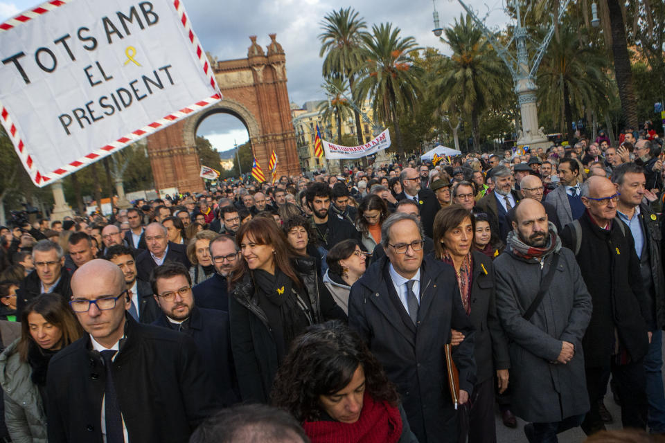 Catalan regional president Quim Torra, centre, walks to the Catalonia's high court in Barcelona, Spain, Monday, Nov.18, 2019. The pro-independence regional president of Catalonia is standing trial for allegedly disobeying Spain's electoral board by not removing pro-secession symbols from public buildings during an election campaign. (AP Photo/Joan Mateu)