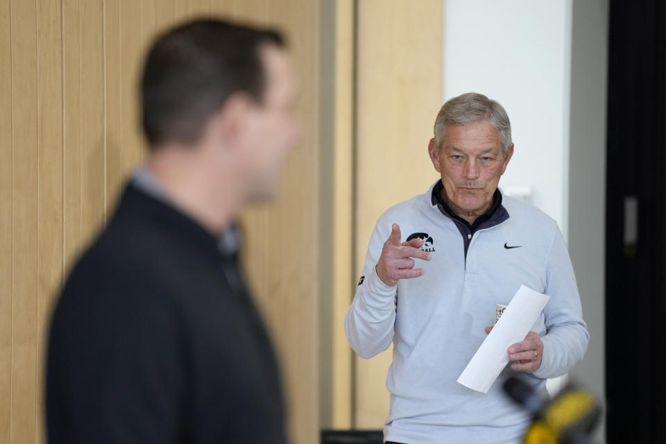 Iowa head football coach Kirk Ferentz, right, listens to new Iowa offensive coordinator Tim Lester speak during an NCAA college football news conference, Tuesday, Feb. 6, 2024, in Iowa City, Iowa. (AP Photo/Charlie Neibergall)