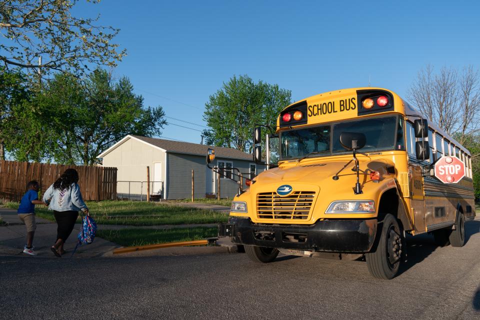 Zytaya Bush takes her son, Zae Morgan-Bush, 11, to the school bus as it comes to a stop Wednesday morning at the intersection of S.E. 40th and Quincy streets.