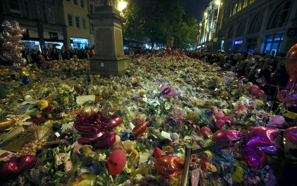 St Ann's Square in Manchester has been filled with tributes to the victims - Credit: Nigel Roddis/EPA