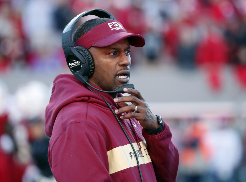 FILE - In this Saturday, Nov. 3, 2018 file photo, Florida State head coach Willie Taggart confers on his headset during the first half of an NCAA college football game against North Carolina State in Raleigh, N.C. Florida State and Miami were hoping signing day could help put to the negativity of 2018 to rest and provide a push toward better times. Coming off a 5-7 record in their first season under coach Willie Taggart, the Seminoles landed a top 20 class but struck out on a much-needed quarterback Wednesday, Feb. 6, 2019. (AP Photo/Chris Seward, File)