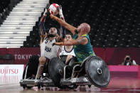 United States' Charles Aoki and Australia's Ryley Batt battle for the ball during a semifinal wheelchair rugby match against Australia at the Tokyo 2020 Paralympic Games, Saturday, Aug. 28, 2021, in Tokyo, Japan. (AP Photo/Kiichiro Sato)