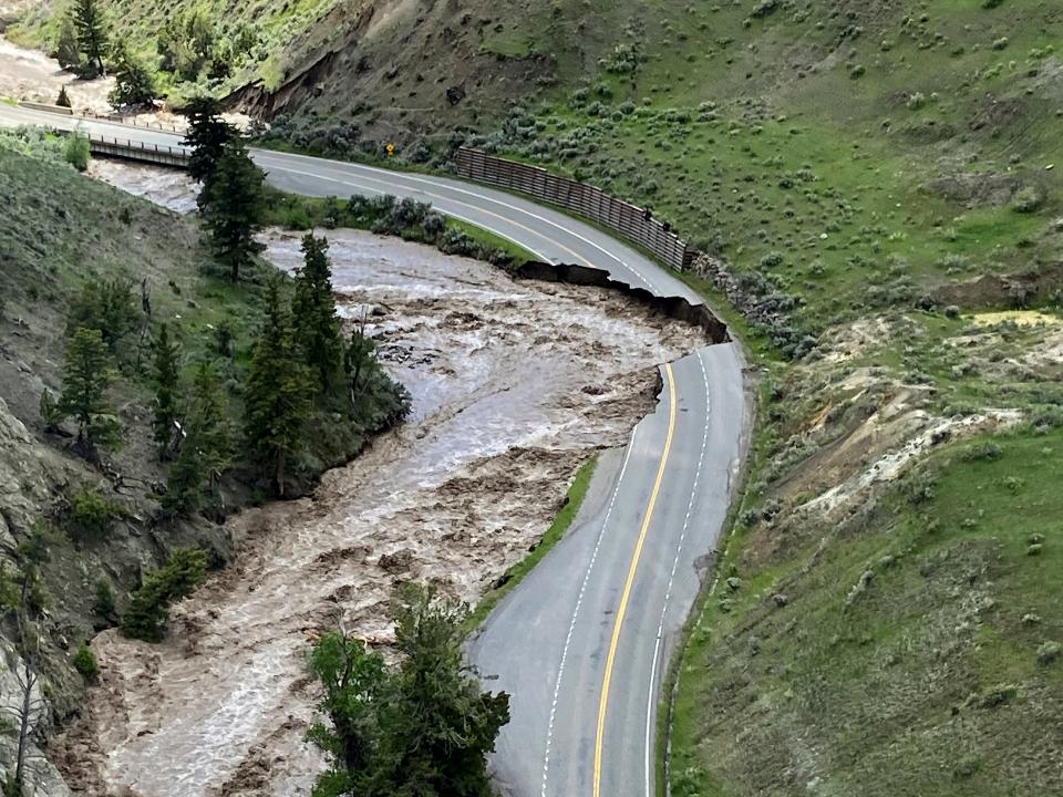 This aerial photo provided by the National Park Service shows a washed out road at North Entrance Road, of Yellowstone National Park in Gardiner, Mont., on June 13, 2022. The flooding was another example of the extreme weather experienced in the U.S. and abroad in 2022.
