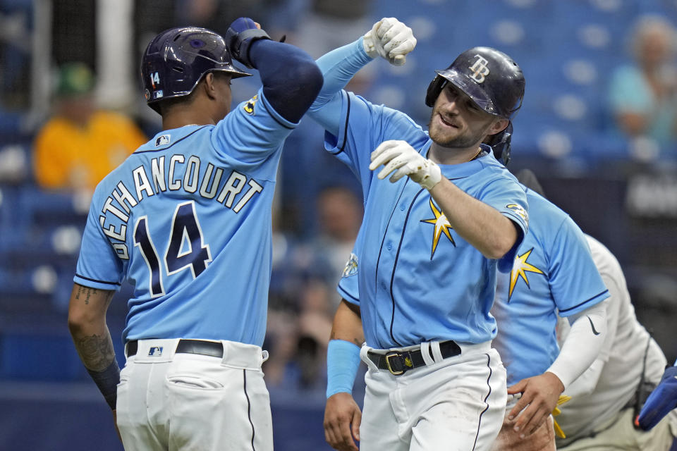 Brandon Lowe, right, and Christian Bethancourt (14) celebrate a home run in a Rays win. (AP Photo/Chris O&#39;Meara)