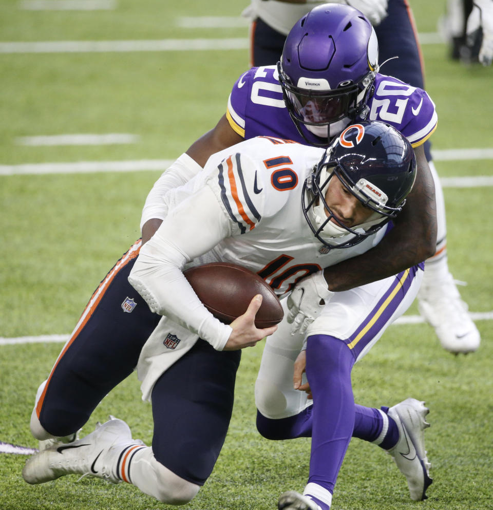 Chicago Bears quarterback Mitchell Trubisky (10 is tackled by Minnesota Vikings cornerback Jeff Gladney (20) during the second half of an NFL football game, Sunday, Dec. 20, 2020, in Minneapolis. (AP Photo/Bruce Kluckhohn)