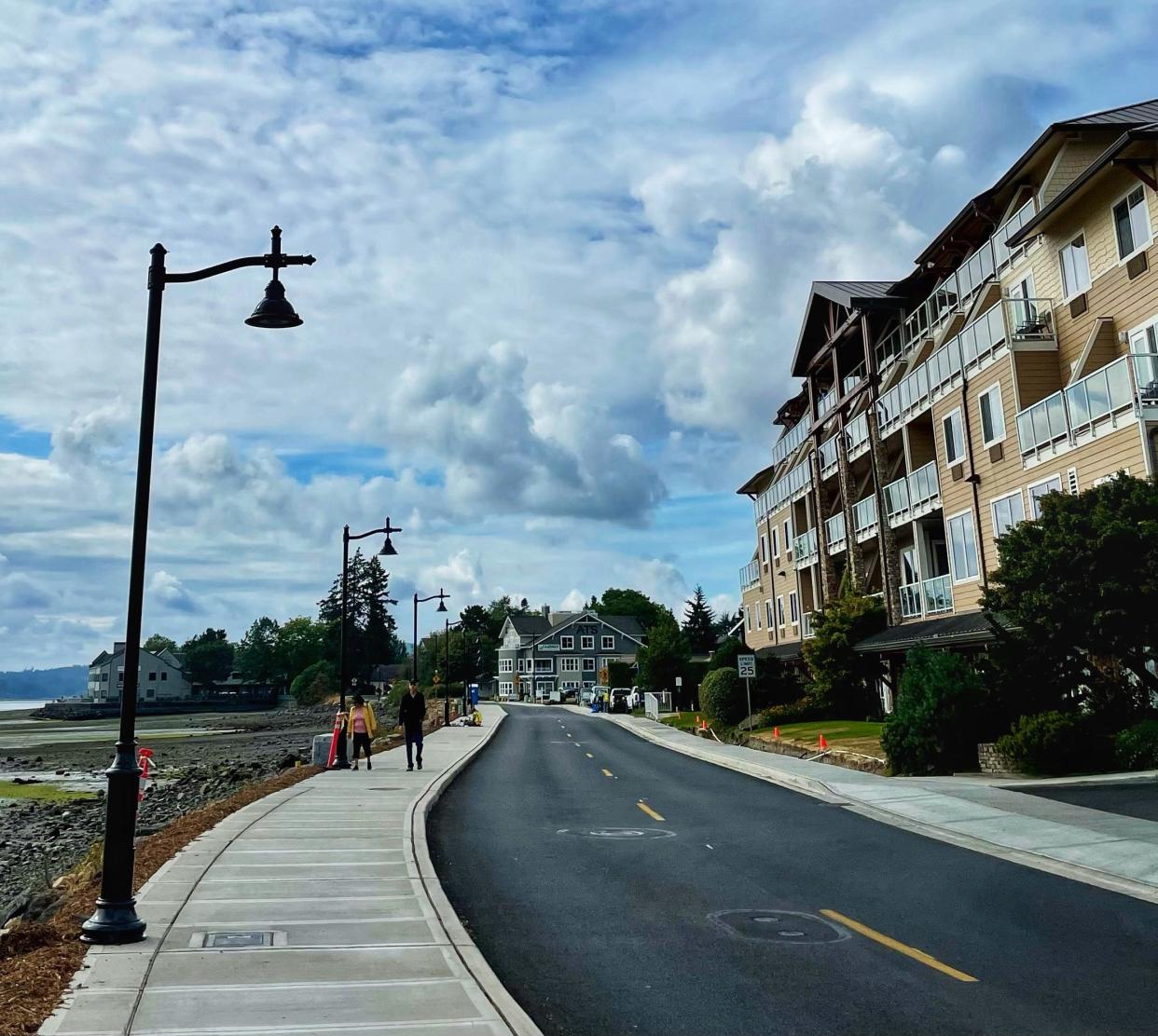 A couple strolls the new sidewalk on Byron Street on Friday. Kitsap County is completing a $26 million project that replaced aging underground infrastructure and placed new sidewalks and street lights around Old Town Silverdale.