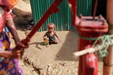 A Rohingya refugee child cries at the camp for widows and orphans inside the Balukhali camp near Cox's Bazar, Bangladesh, December 5, 2017. More than 230 women and children live at a so-called widows camp built by fellow refugees with the help of donor funds for Rohingya widows and orphans to offer them better protection and shelter. REUTERS/Damir Sagolj