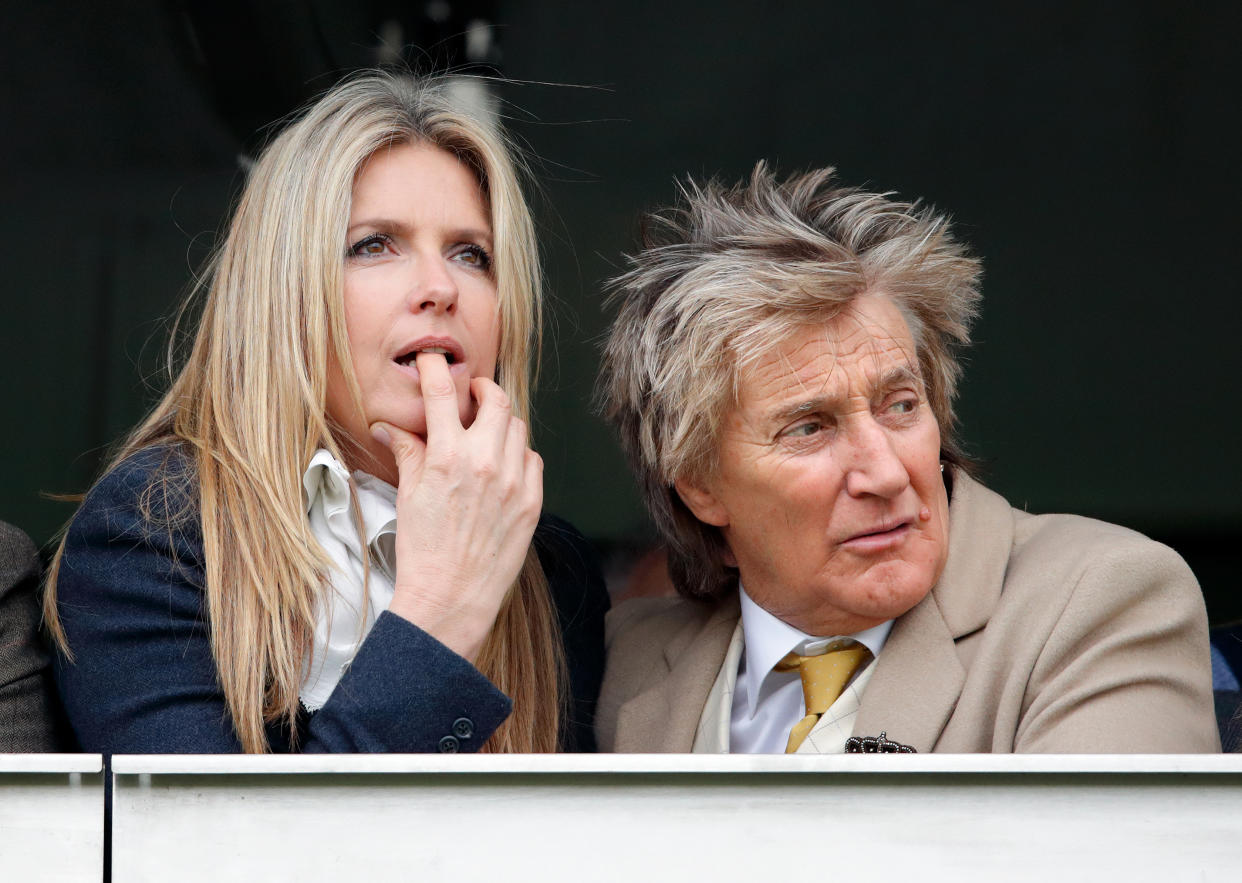 CHELTENHAM, UNITED KINGDOM - MARCH 14: (EMBARGOED FOR PUBLICATION IN UK NEWSPAPERS UNTIL 24 HOURS AFTER CREATE DATE AND TIME) Penny Lancaster and Sir Rod Stewart watch the racing as they attend day 3 'St Patrick's Thursday' of the Cheltenham Festival at Cheltenham Racecourse on March 14, 2019 in Cheltenham, England. (Photo by Max Mumby/Indigo/Getty Images)
