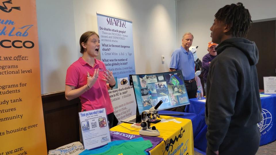 A volunteer at ECCO Aquarium talks about volunteer opportunities during the Hendersonville High School's Symposium on Oct. 19 at HHS.