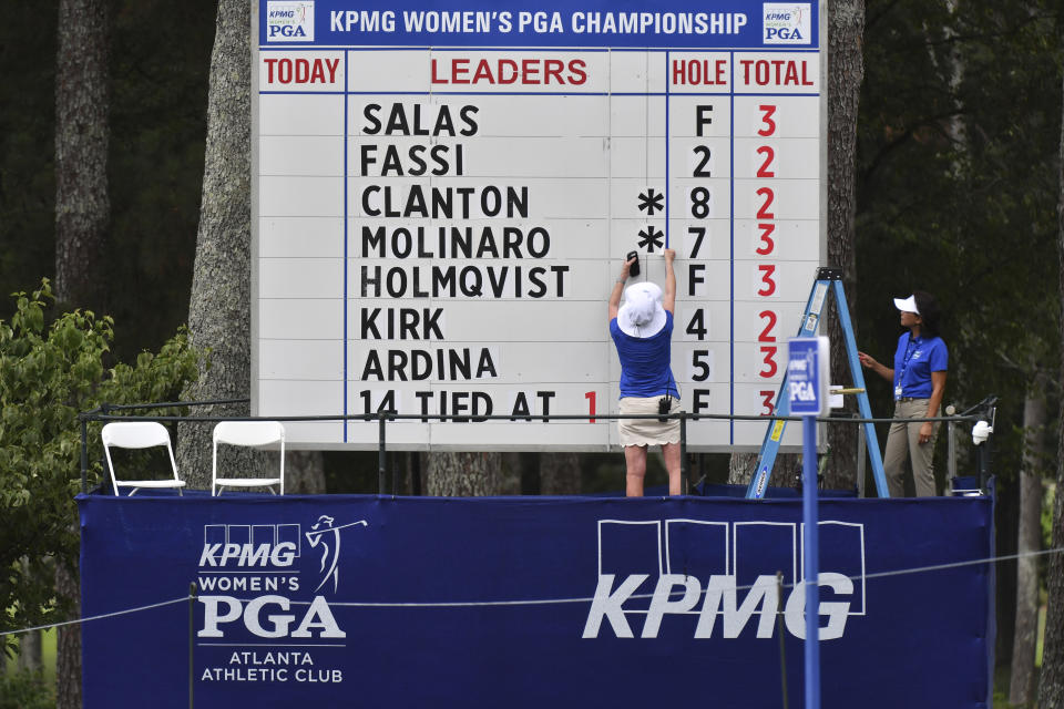 Event staff change scores on a leaderboard during the first round of the Women's PGA Championship golf tournament at Atlanta Athletic Club in Johns Creek, Ga., Thursday, June 24, 2021. (Hyosub Shin/Atlanta Journal-Constitution via AP)