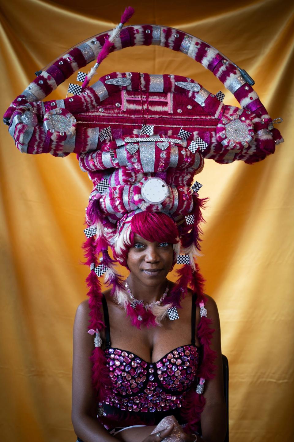 Kima Hall, 43, of Detroit, sits for a portrait before the Hair Wars and Hot Cars runway show at Ford Community and Performing Arts Center in Dearborn on Sunday, Sept. 18, 2022. "We're ready to get back on the stage," said Hall, who has been walking in Matthews' show for more than 10 years.