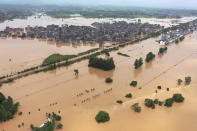 Floodwaters flow around a town in Shangrao in central China's Jiangxi province, Tuesday, June 21, 2022. Major flooding has forced the evacuation of tens of thousands of people in southern China, with more rain expected. (Chinatopix via AP)