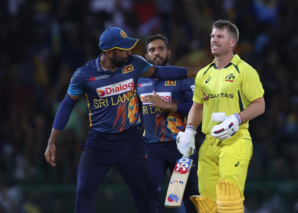 David Warner (pictured right) walks off the field after being dismissed on 99.