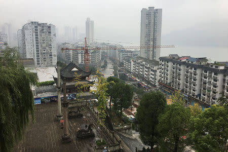 A construction crane is seen in a general view of Zhongxian, Chongqing, China November 13, 2017. REUTERS/ Yawen Chen