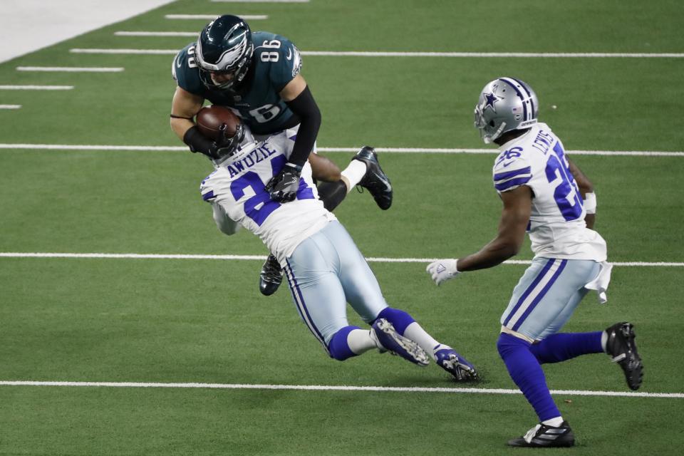 Dallas Cowboys cornerback Chidobe Awuzie (24) stops Philadelphia Eagles tight end Zach Ertz (86) from gaining extra yardage after a catch as cornerback Jourdan Lewis (26) looks on in the second half of an NFL football game in Arlington, Texas, Sunday, Dec. 27. 2020. (AP Photo/Roger Steinman)